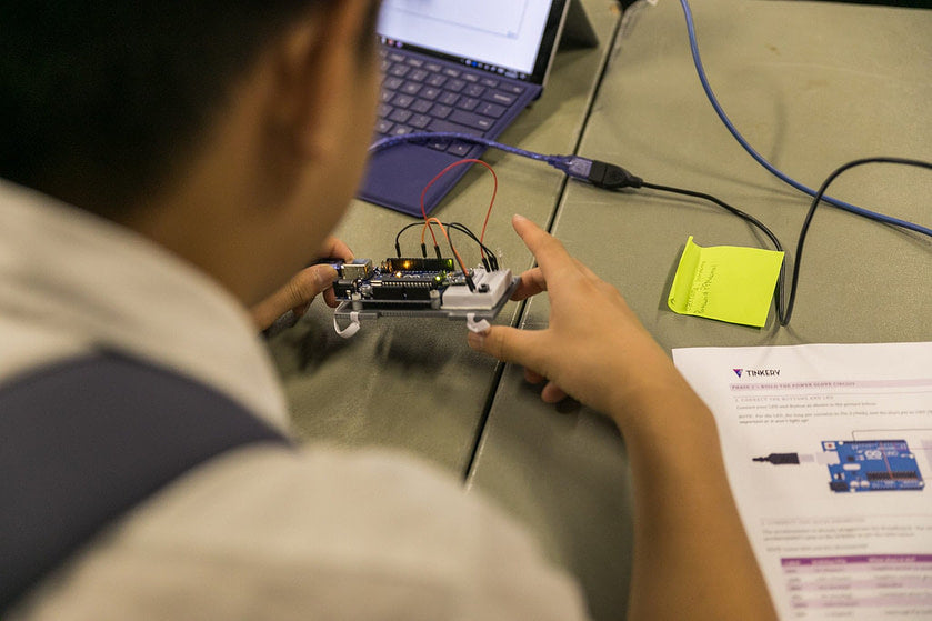 High school student playing with wearable sensor board